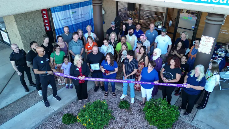 The Rise Up Benefits Group ribbon cutting outside the Chandler office, with neighbors and clients gathered under the Medicare, Health, Life sign